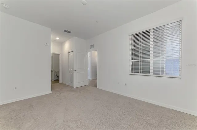 a view of an empty room with a window