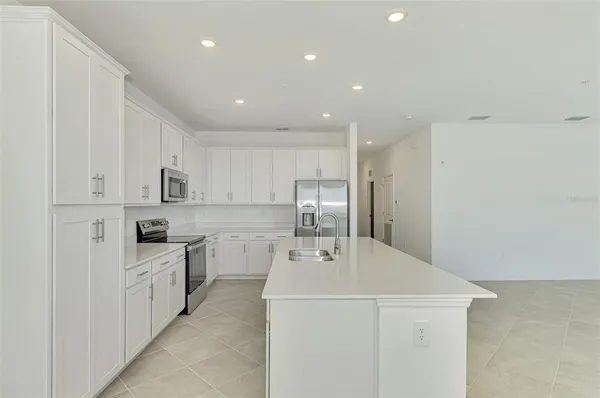a kitchen with a sink a stove and refrigerator