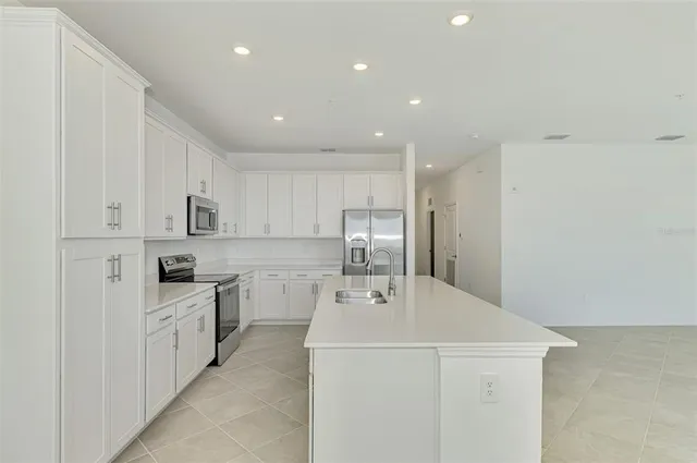 a kitchen with a sink a stove and refrigerator