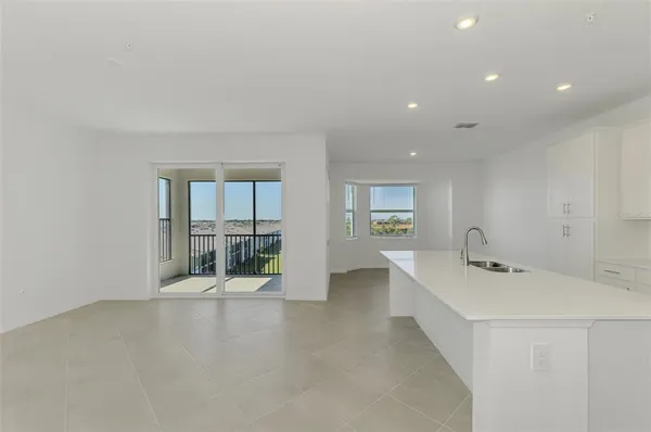 a hallway with a sink and mirror
