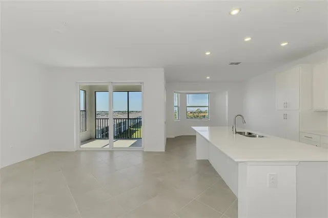 a hallway with a sink and mirror