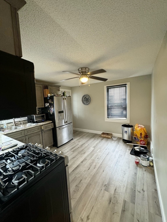 21 Morison Terrace Springfield, MA 01104 - Photo 11 of 42 a kitchen with stainless steel appliances granite countertop a stove and a refrigerator