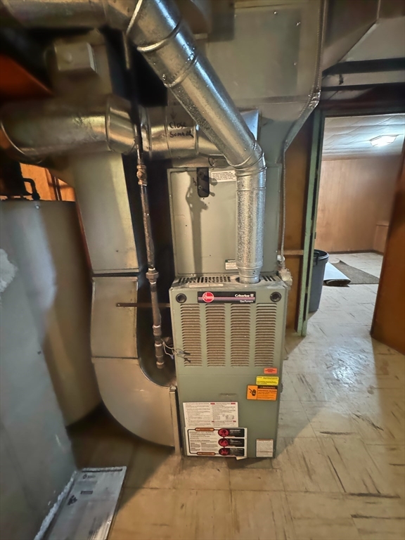 21 Morison Terrace Springfield, MA 01104 - Photo 36 of 42 a room with water heater and wooden floors