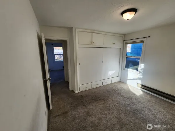 a view of walk in closet with empty racks