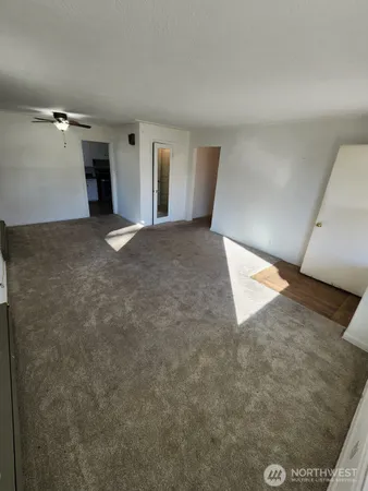 a view of a big room with closet and windows