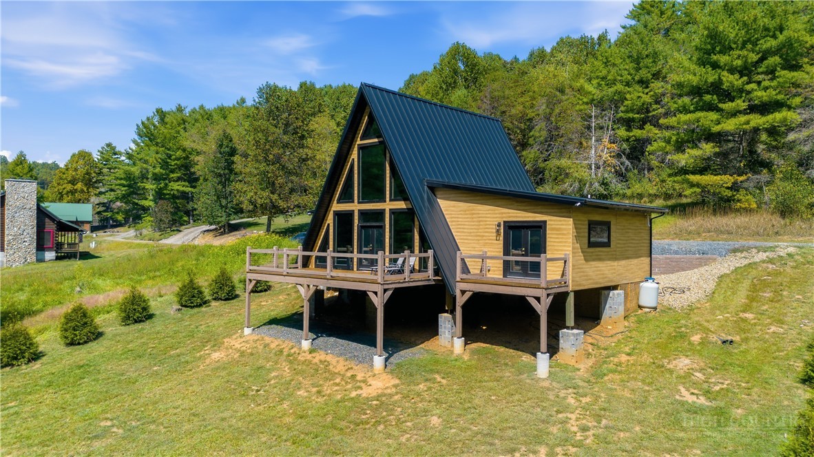355 South River Hills Road Lansing, NC 28643 - Photo 40 of 45 a view of house with swimming pool and outdoor seating