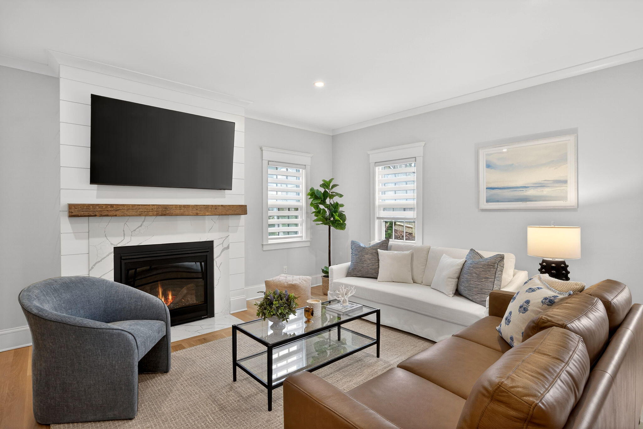 255 Old Main Road, Unit 1B North Falmouth, MA 02556 - Photo 11 of 88 a living room with furniture a flat screen tv and a fireplace