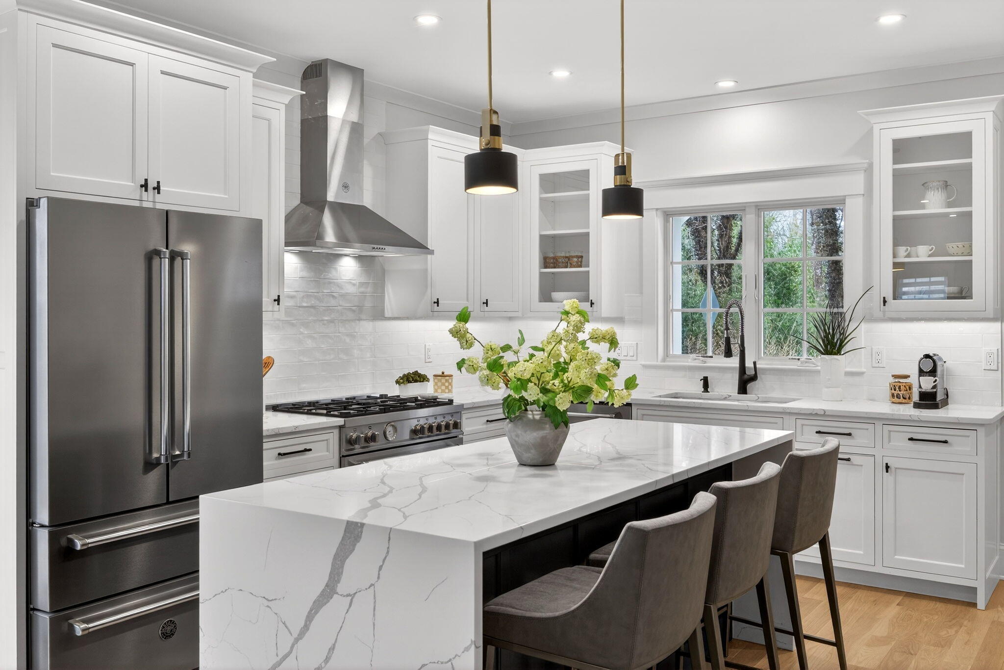 255 Old Main Road, Unit 1B North Falmouth, MA 02556 - Photo 5 of 88 a kitchen with stainless steel appliances a dining table chairs refrigerator and stove
