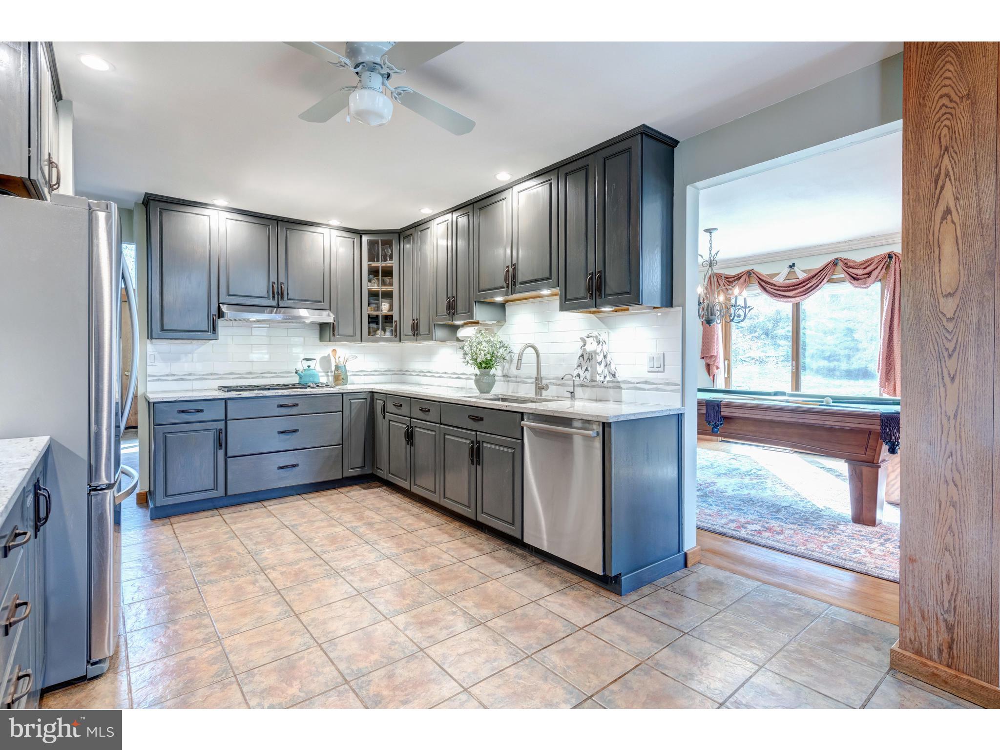 535 Upper Weadley Road Wayne, PA 19087 - Photo 25 of 44 a kitchen with stainless steel appliances granite countertop a stove a sink and a refrigerator