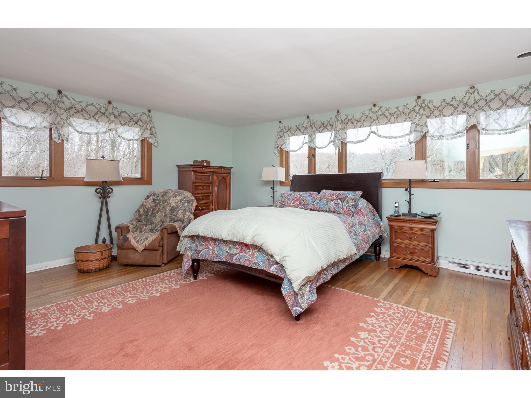 535 Upper Weadley Road Wayne, PA 19087 - Photo 28 of 44 a bedroom with a bed a table and chair