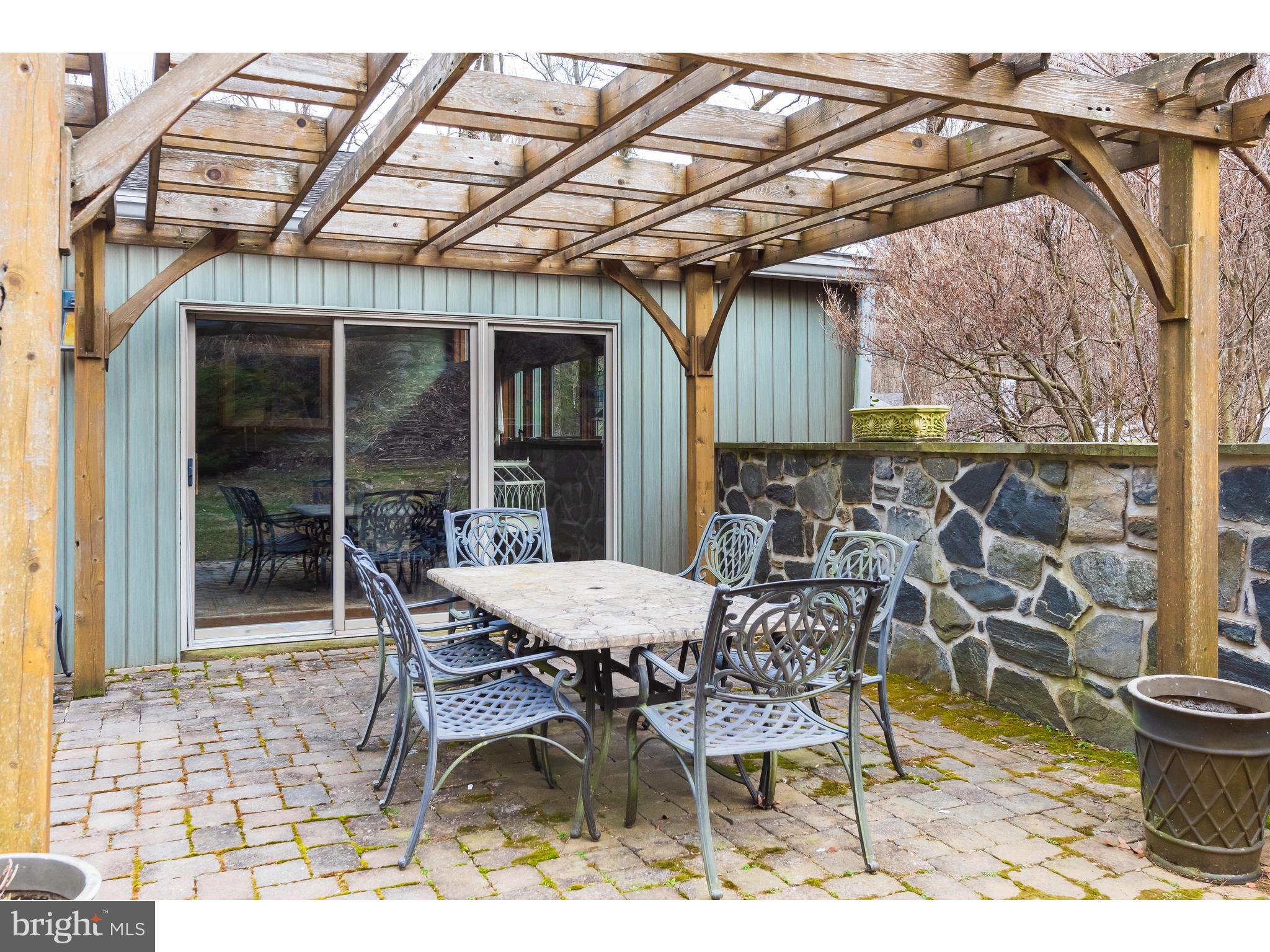 535 Upper Weadley Road Wayne, PA 19087 - Photo 8 of 44 a patio with a table and chairs