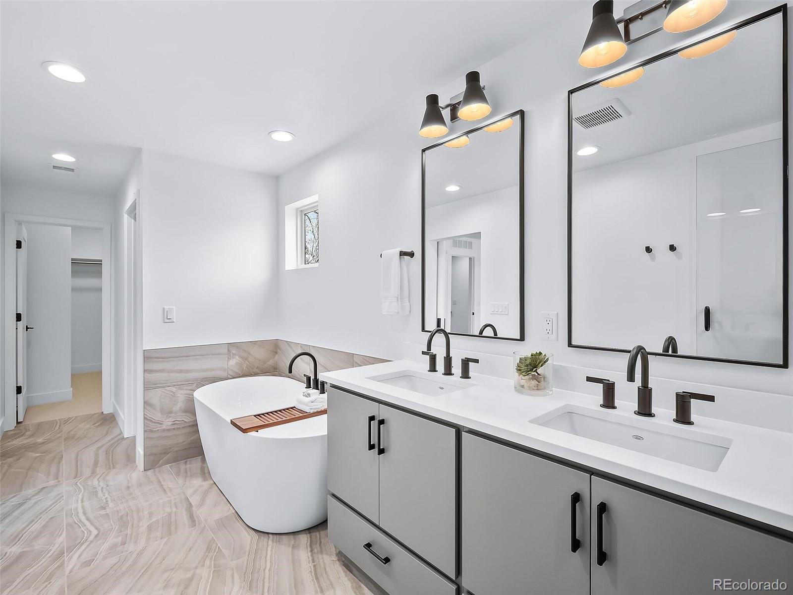 588 Adams Street Denver, CO 80206 - Photo 15 of 41 a bathroom with a double vanity sink mirror and bathtub