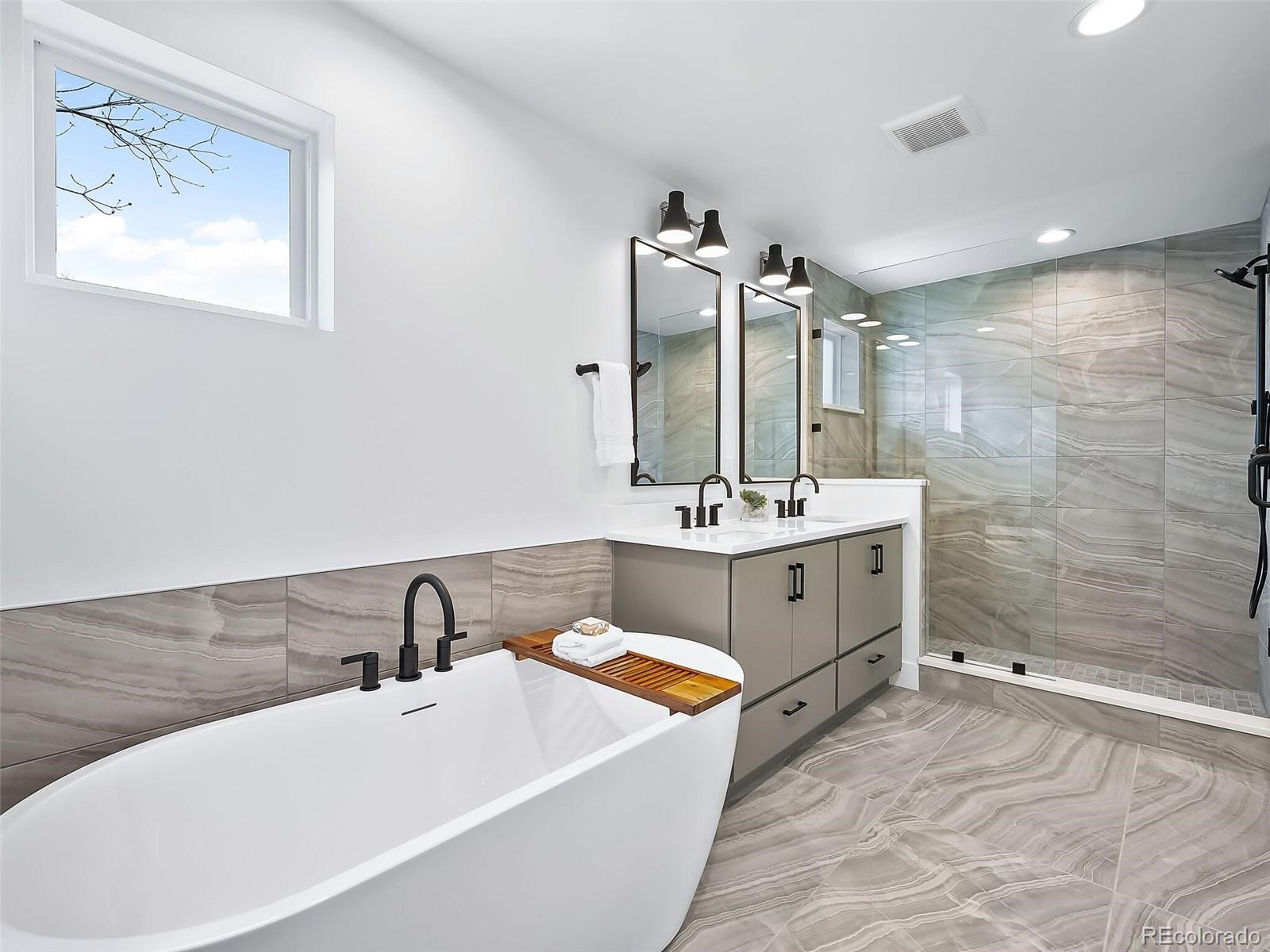 588 Adams Street Denver, CO 80206 - Photo 16 of 41 a bathroom with a double vanity sink mirror and bathtub