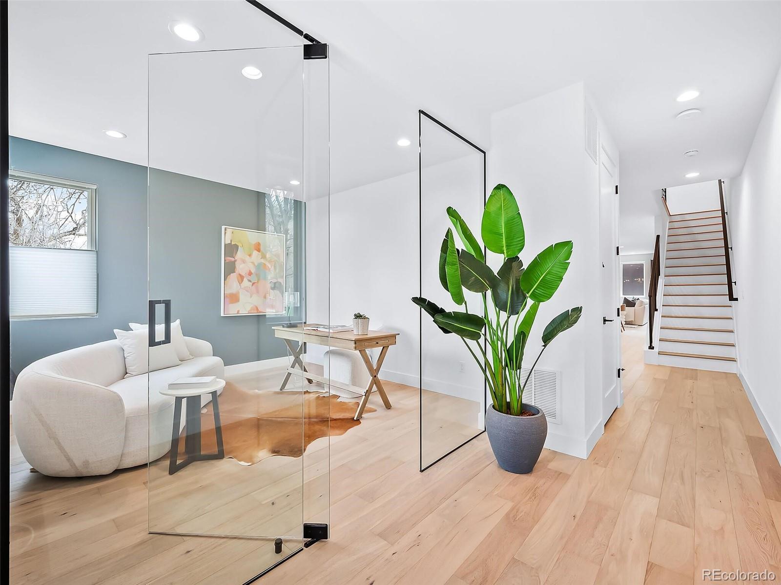 588 Adams Street Denver, CO 80206 - Photo 2 of 41 a living room with furniture a potted plant and a rug