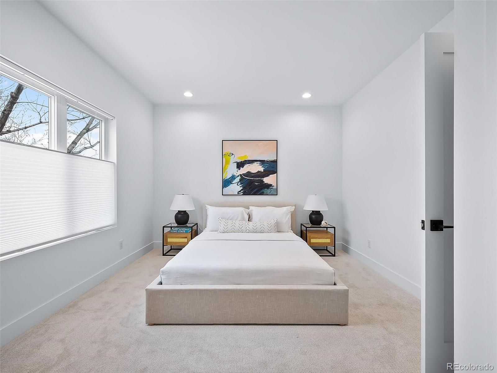 588 Adams Street Denver, CO 80206 - Photo 22 of 41 a bedroom with a bed and wall paintings