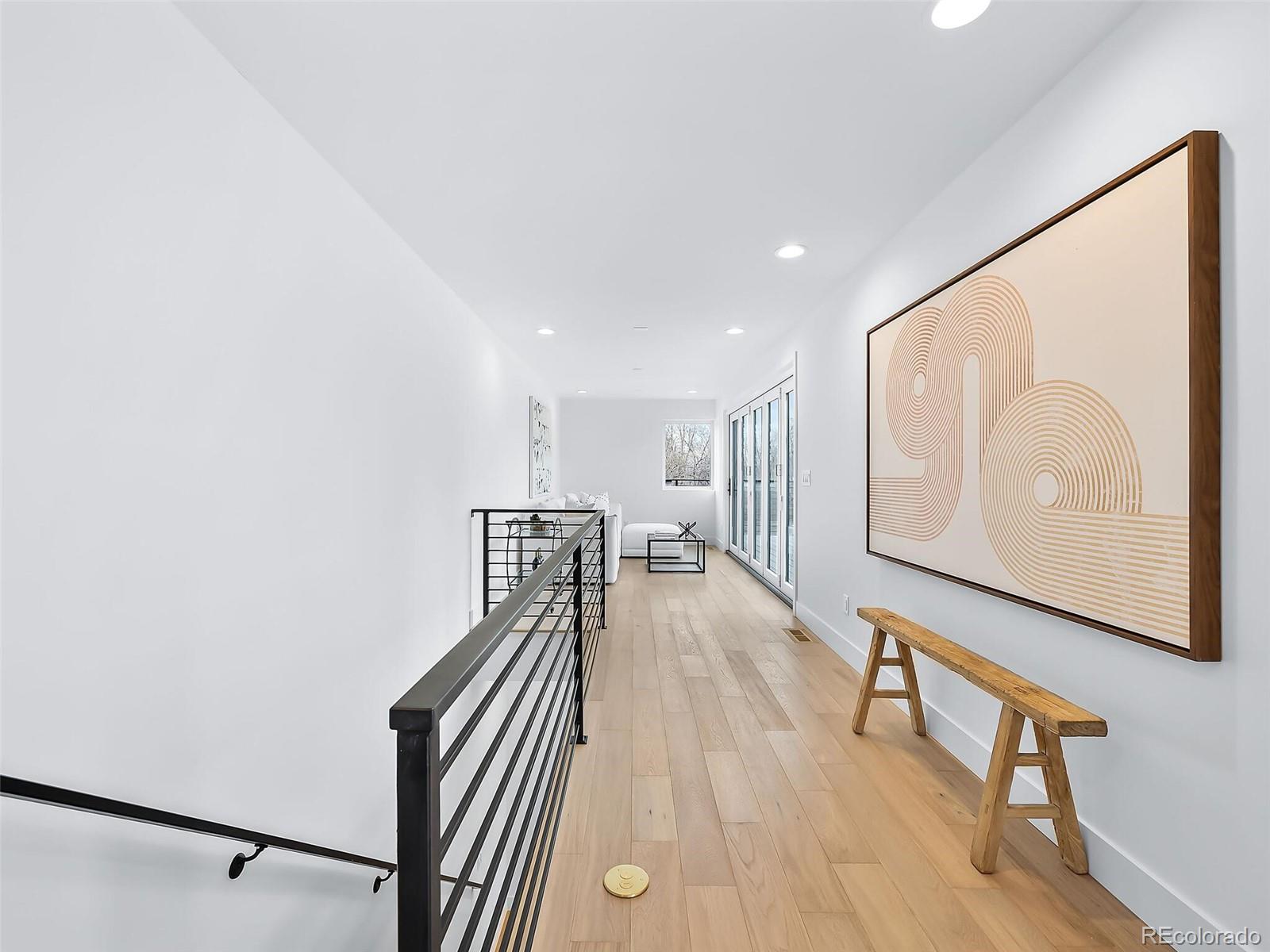 588 Adams Street Denver, CO 80206 - Photo 23 of 41 a view of a hallway with wooden floor