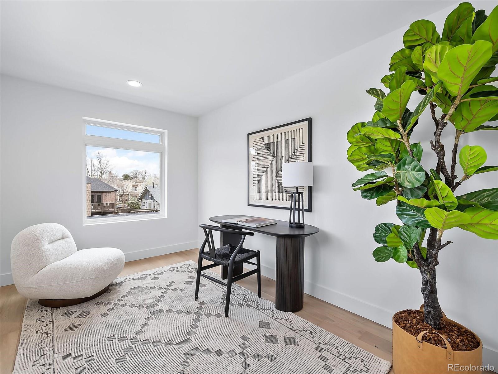 588 Adams Street Denver, CO 80206 - Photo 24 of 41 a living room with furniture potted plant and a window