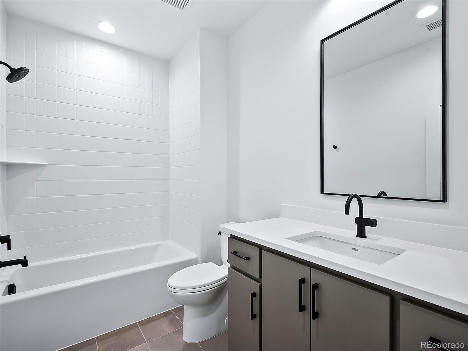 588 Adams Street Denver, CO 80206 - Photo 31 of 41 a bathroom with a sink a toilet and shower