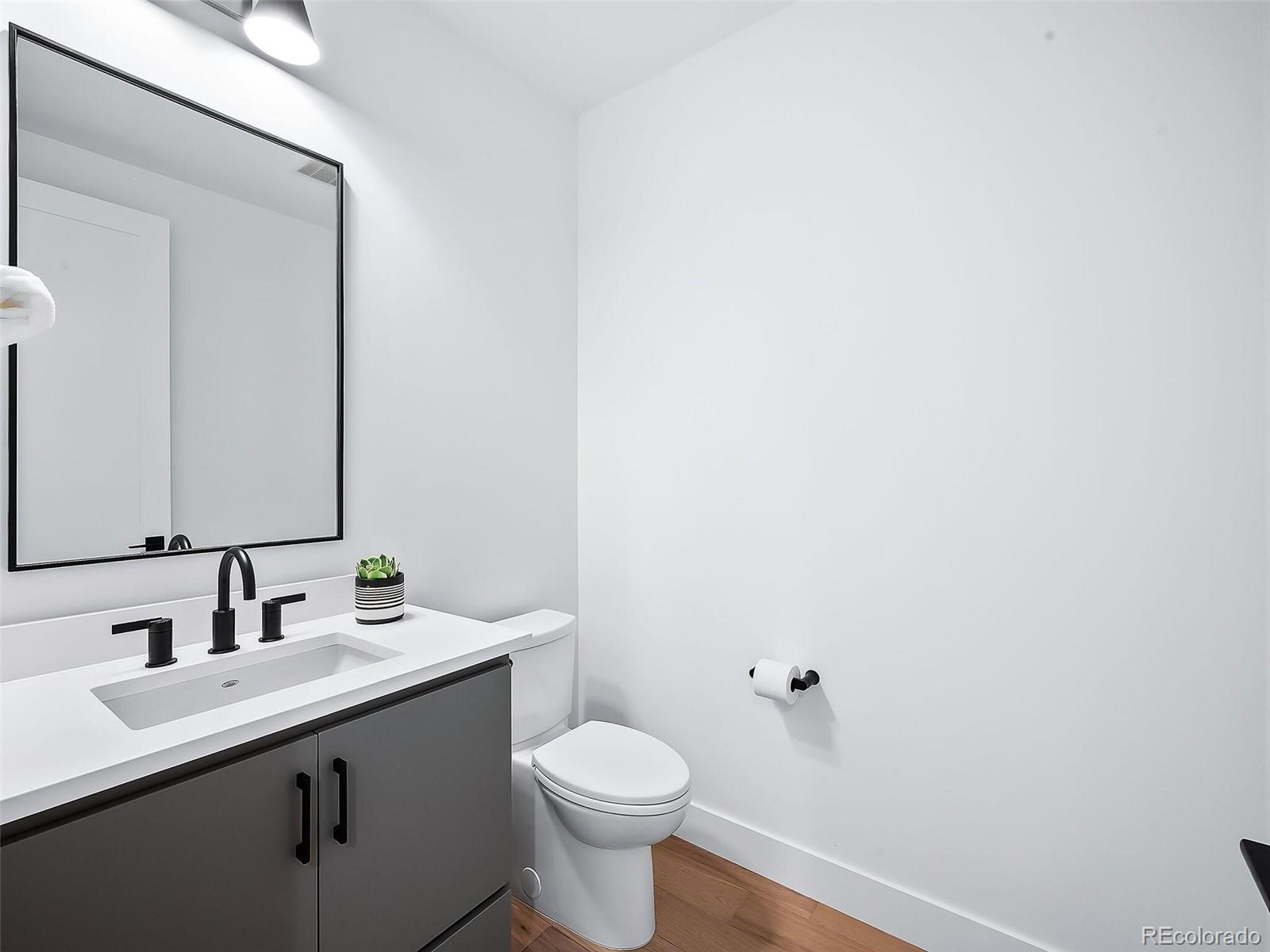 588 Adams Street Denver, CO 80206 - Photo 10 of 41 a bathroom with a sink and a toilet