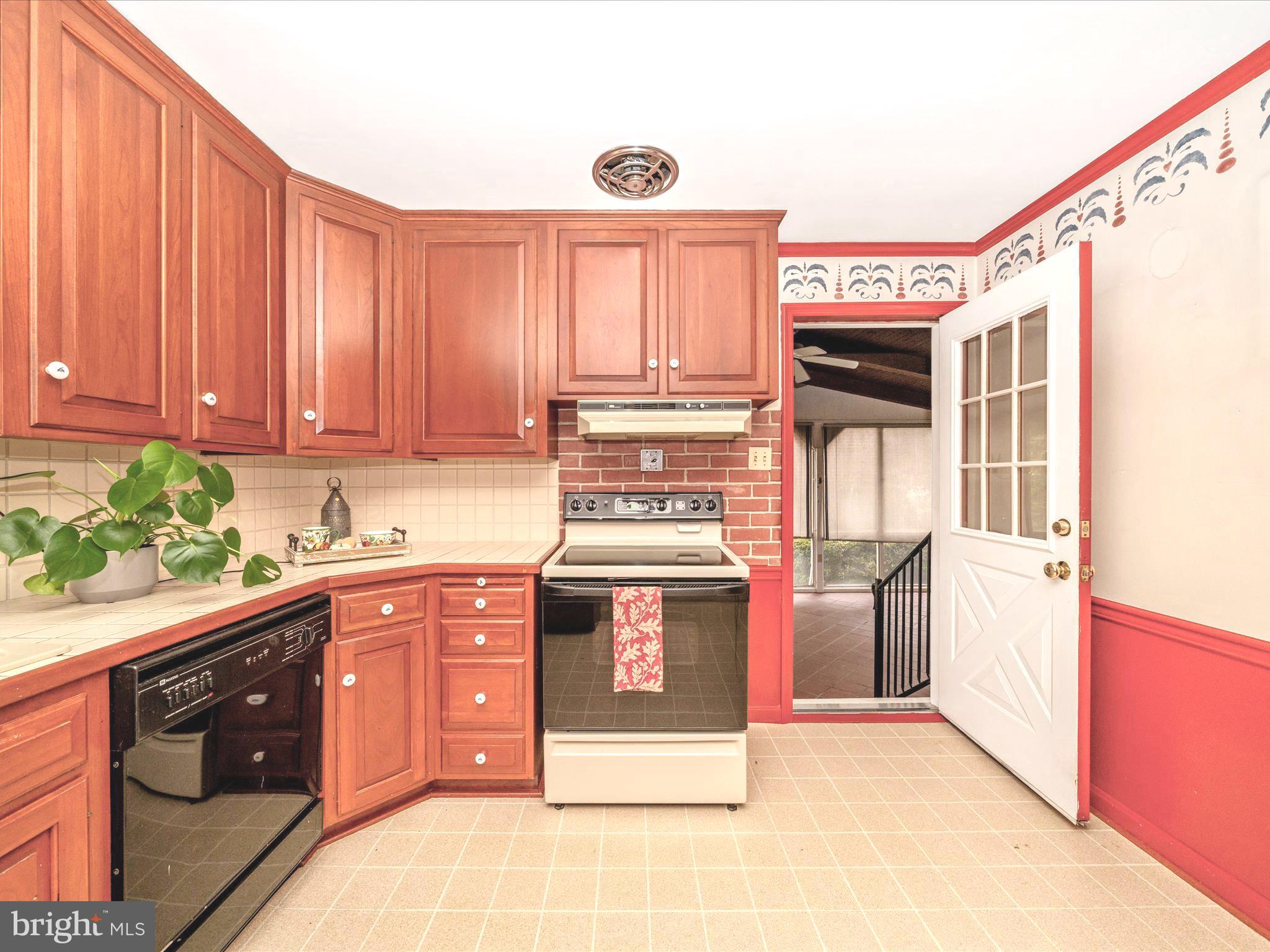 17920 Pin Oak Road Hagerstown, MD 21740 - Photo 11 of 57 a kitchen with stainless steel appliances granite countertop a stove a sink and a microwave