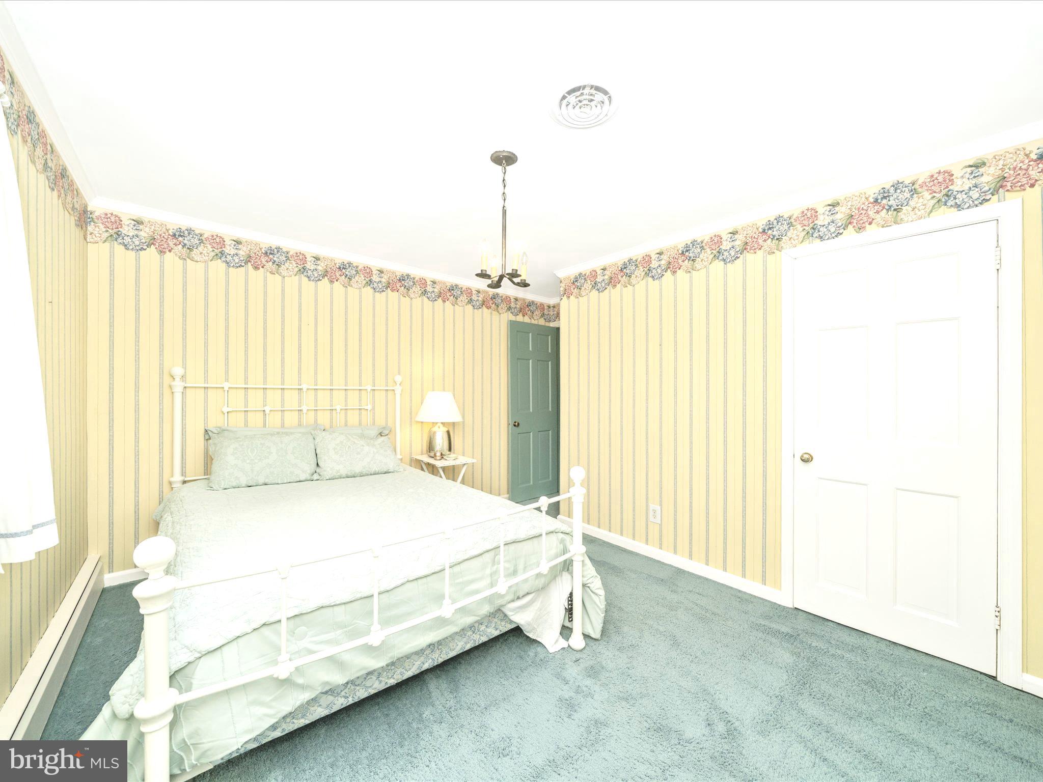 17920 Pin Oak Road Hagerstown, MD 21740 - Photo 28 of 57 a bedroom with a bed and a chandelier