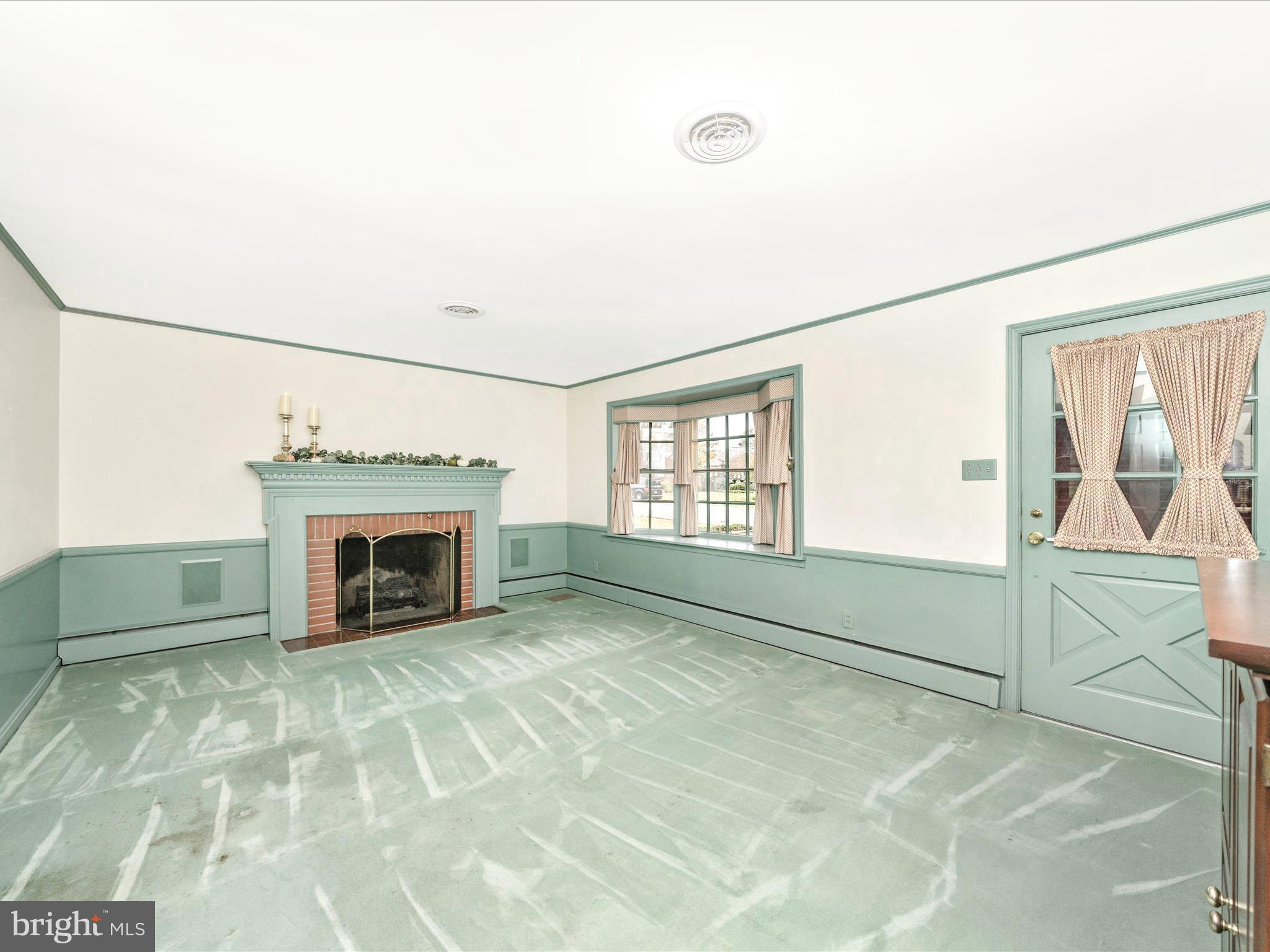 17920 Pin Oak Road Hagerstown, MD 21740 - Photo 6 of 57 a view of an empty room with a fireplace and a window