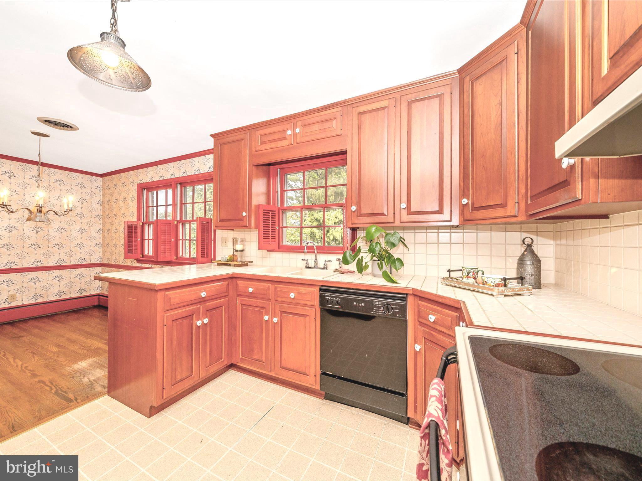 17920 Pin Oak Road Hagerstown, MD 21740 - Photo 10 of 57 a kitchen with stainless steel appliances granite countertop a sink and dishwasher a stove with wooden floor