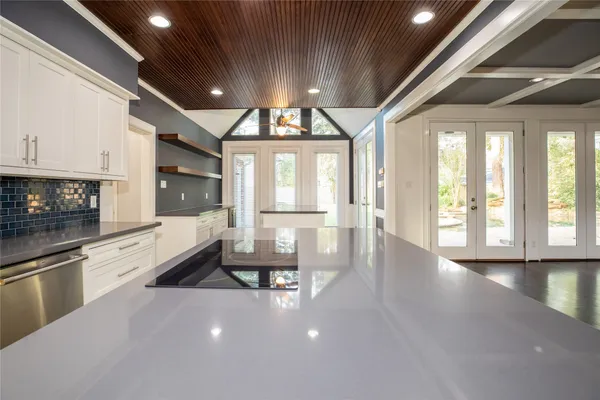 a view of an empty room with a fireplace and a window