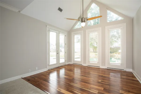a bathroom with a granite countertop double vanity sink a mirror and a bathtub