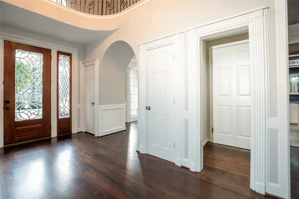 a large white kitchen with stainless steel appliances granite countertop a stove and a sink