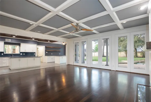 a large white kitchen with a sink and cabinets