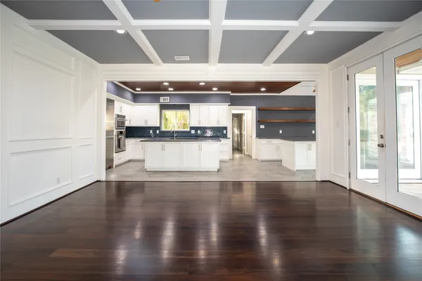 a large white kitchen with a large window