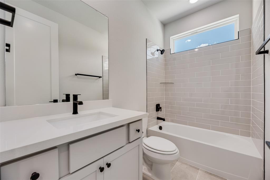 817 Ash Road Plano, TX 75075 - Photo 18 of 23 a bathroom with a sink a toilet and a bathtub