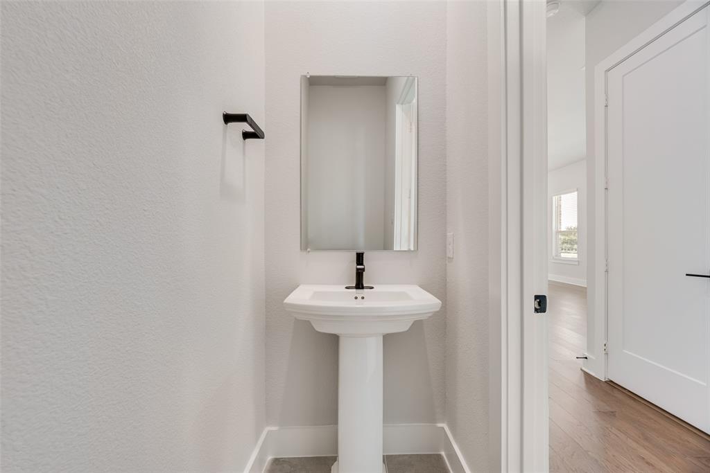 817 Ash Road Plano, TX 75075 - Photo 21 of 23 a sink and a mirror with shower