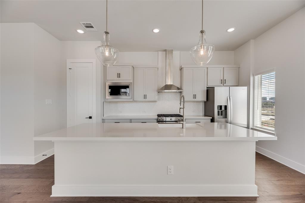 817 Ash Road Plano, TX 75075 - Photo 6 of 23 a large kitchen with stainless steel appliances a large counter top