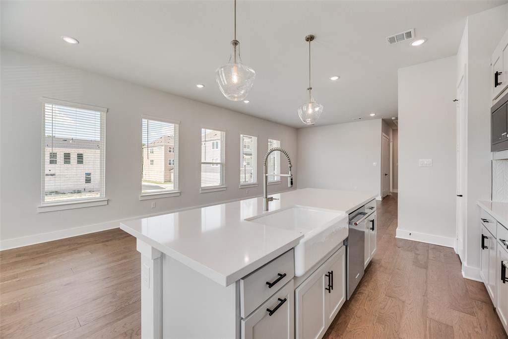 817 Ash Road Plano, TX 75075 - Photo 7 of 23 a large kitchen with kitchen island a large island in it