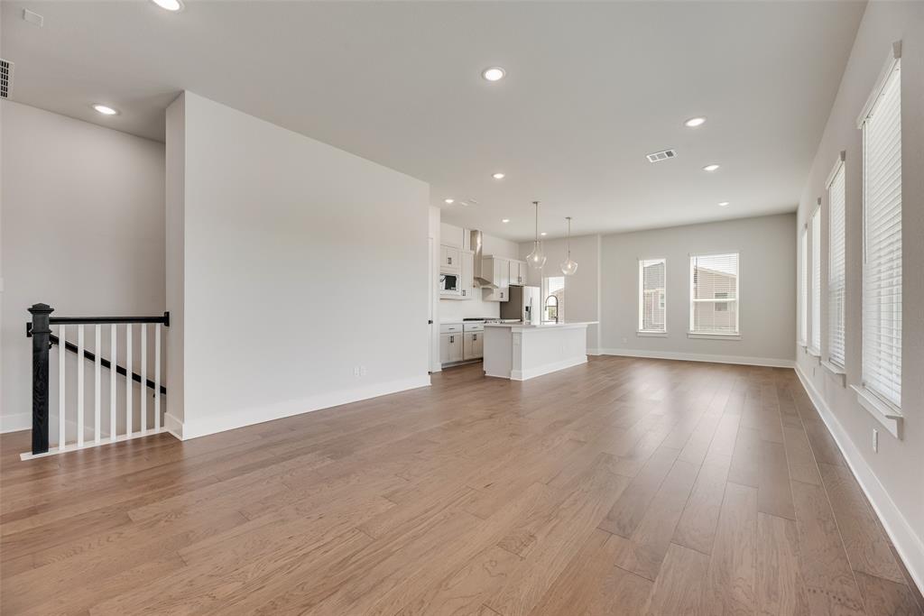 817 Ash Road Plano, TX 75075 - Photo 10 of 23 a view of an empty room with a window and wooden floor