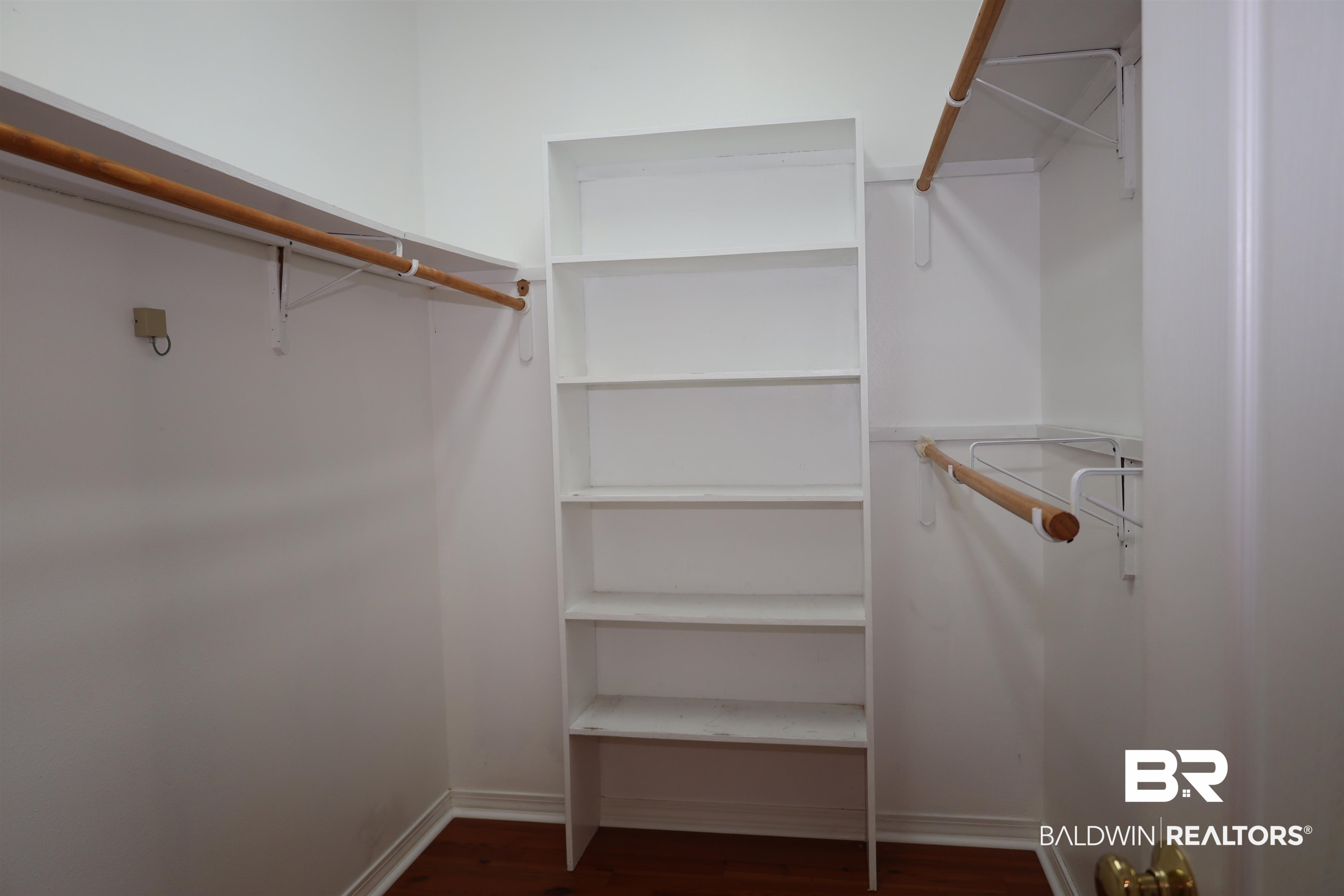 111 Destrehan Road Fairhope, AL 36532 - Photo 13 of 29 Walk in closet featuring dark wood-type flooring