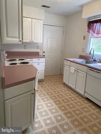 a kitchen with stainless steel appliances granite countertop a sink and cabinets
