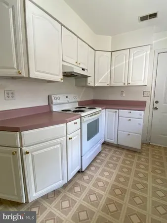 a kitchen with a stove and a refrigerator