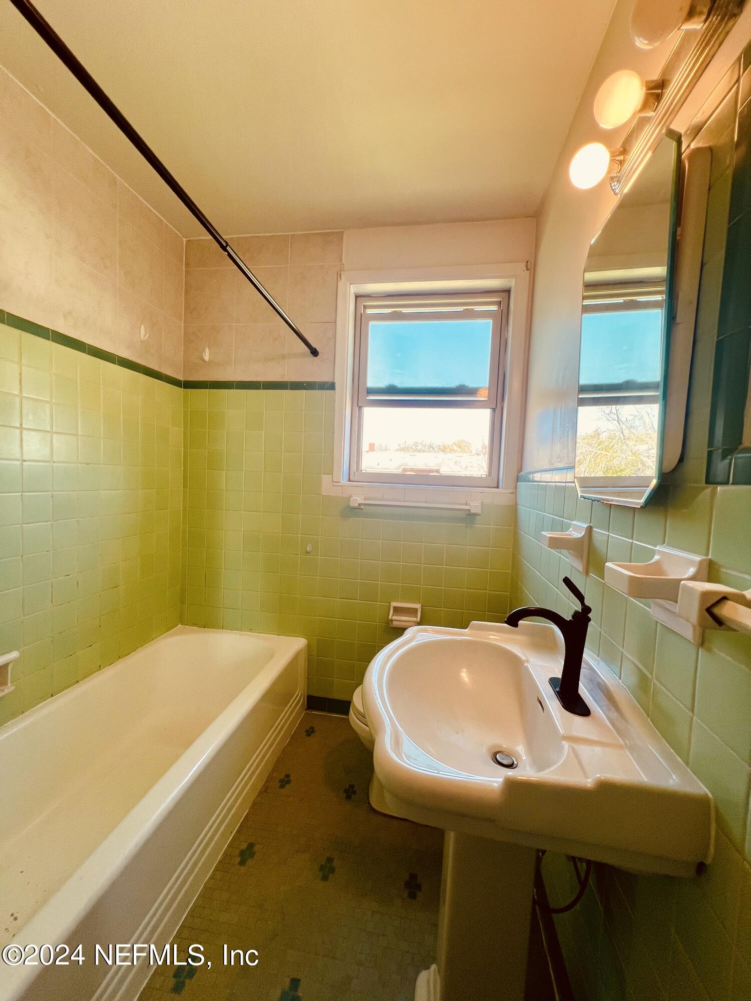 1781 River Road, Unit 4 Jacksonville, FL 32207 - Photo 16 of 24 a bathroom with a sink and a mirror