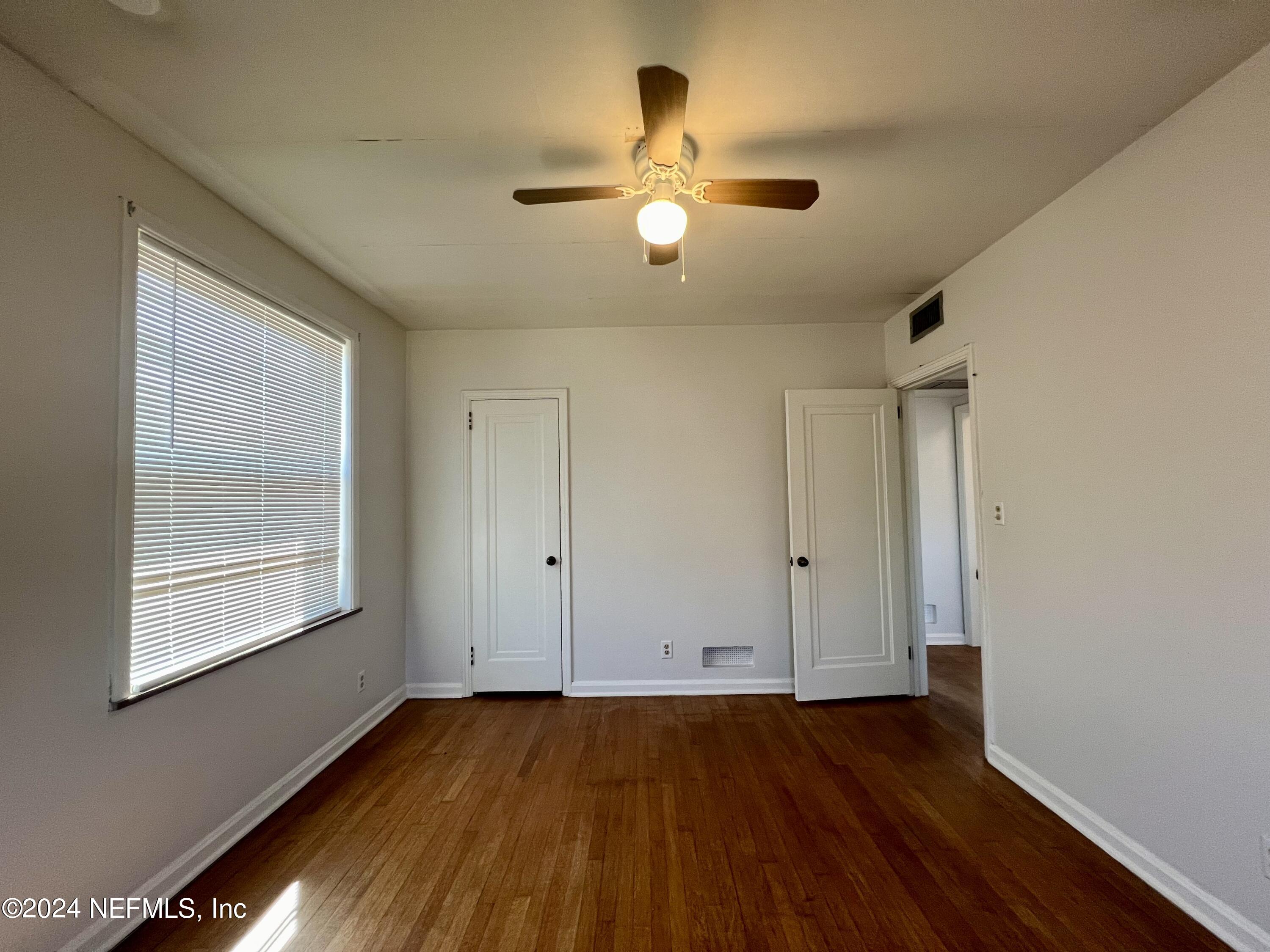 1781 River Road, Unit 4 Jacksonville, FL 32207 - Photo 18 of 24 a view of an empty room with wooden floor and a window