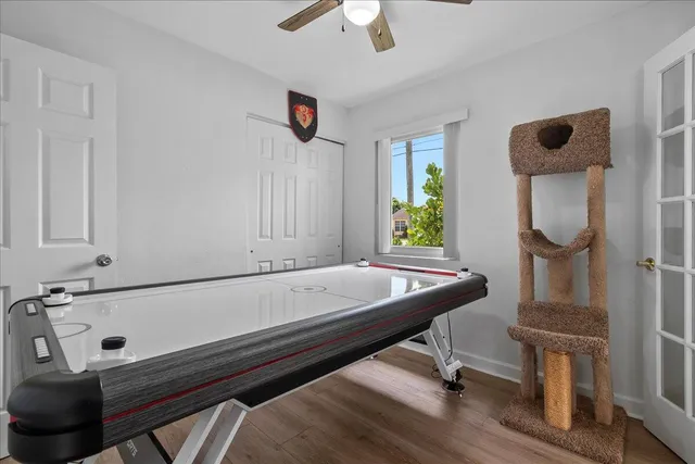 a room with pool table and windows