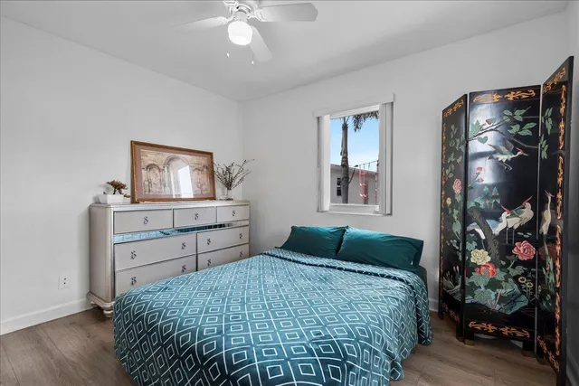 a bedroom with a bed and a dresser in it