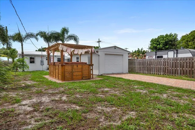 a view of a house with yard and a garden
