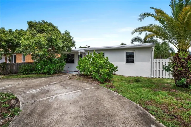 a front view of house with yard and trees