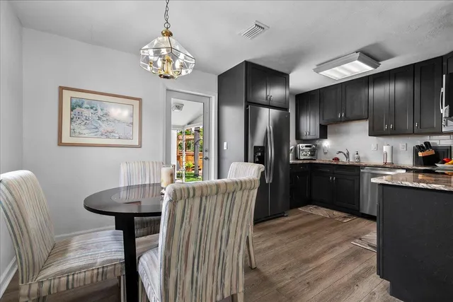 a kitchen with granite countertop a refrigerator and a stove