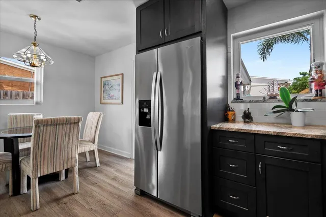 a kitchen with stainless steel appliances granite countertop a refrigerator and a sink