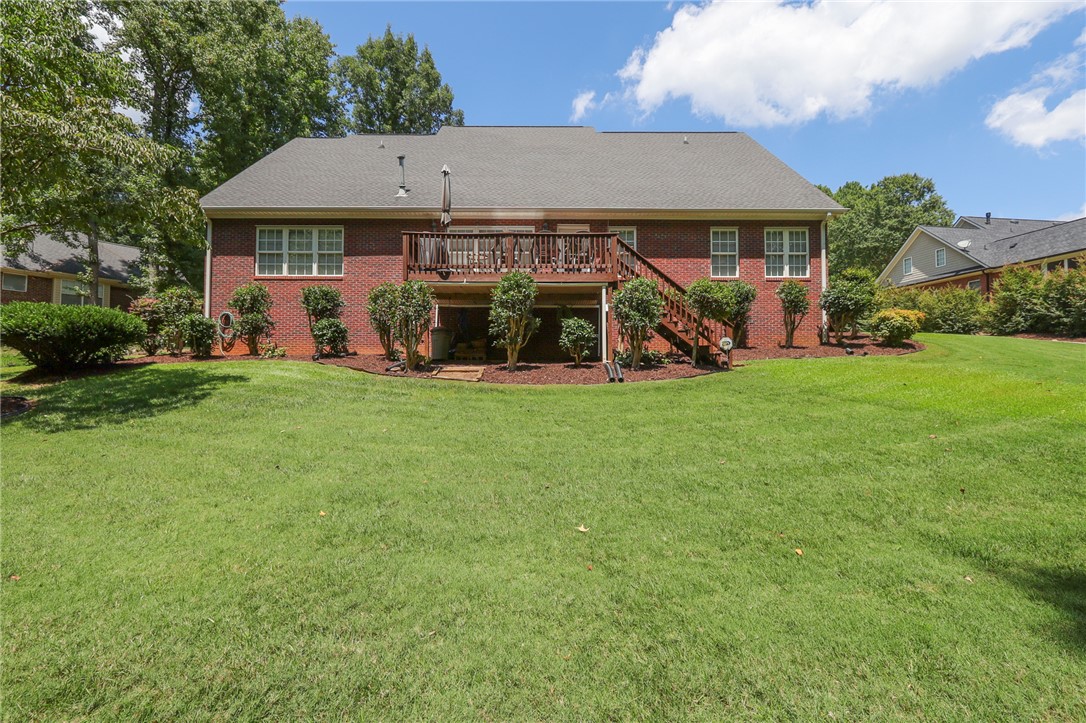 103 C-10-147D Anderson, SC 29621 - Photo 43 of 49 A spacious backyard with mature trees complements this charming brick residence, featuring a walk-out deck and ample green space.