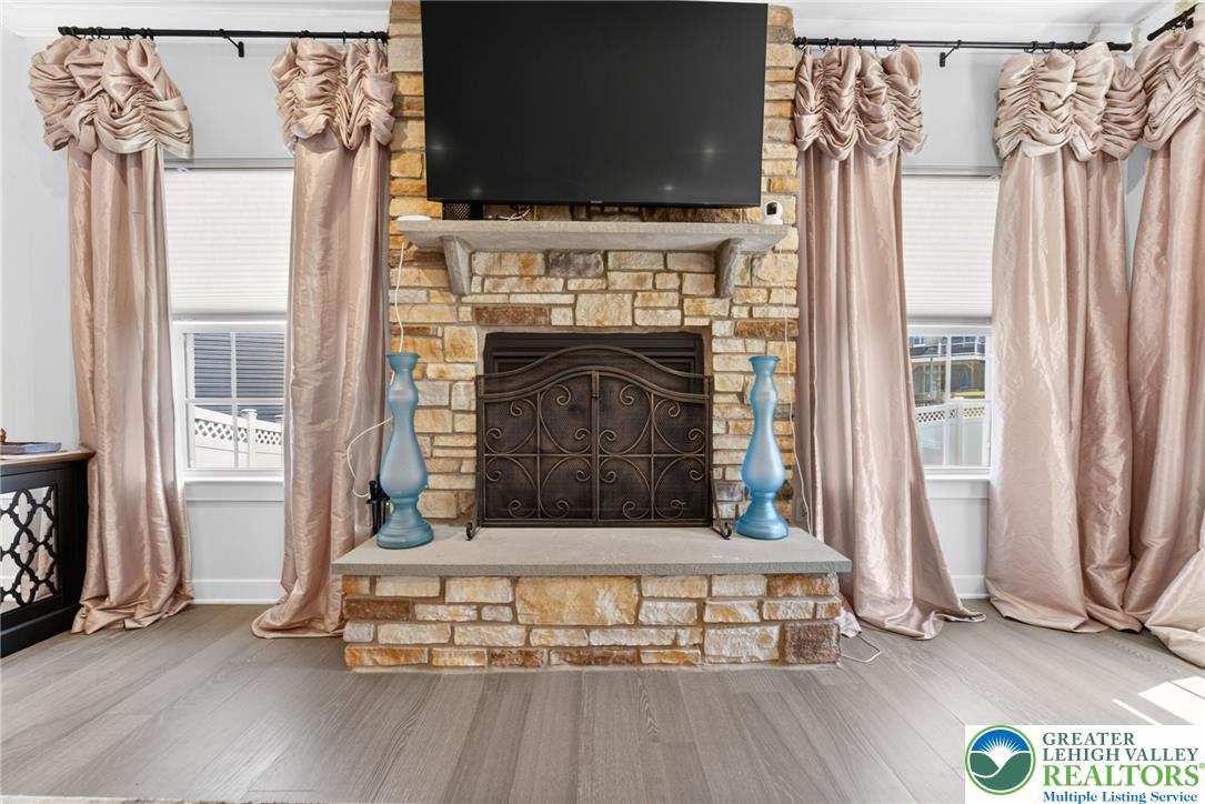 3952 Orth Street Bethlehem, PA 18020 - Photo 14 of 60 An inviting hearth crafted from natural stone anchors this bright and cozy living space.